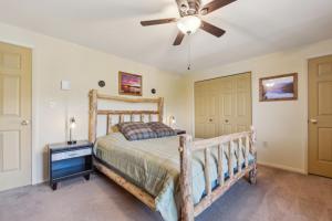 a bedroom with a bed and a ceiling fan at Straight Brook 5D - Adirondack-Style Townhome in North Creek