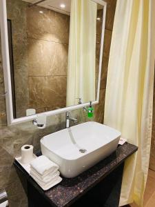 a bathroom with a sink and a mirror at Zip By Spree Hotels Neelam Nakshatra in Kudal