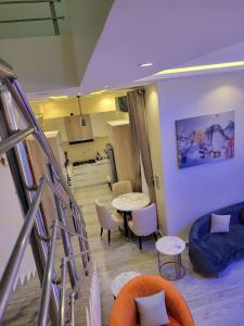 a living room with a staircase and a table and chairs at Jec Residences in Lekki
