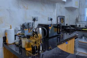a kitchen with a counter top with utensils at Suzzy homestays 1 in Meru +2 photos