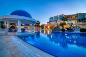 a large swimming pool in front of a building at Marcellus Iskele Resort Ceasar in Larnaca +15 photos