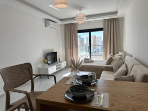 a living room with a table and a couch at Marcellus Iskele Resort Ceasar in Larnaca