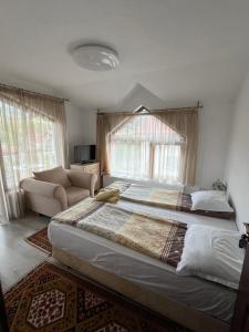 Postel nebo postele na pokoji v ubytování Bayrakova Guest House
