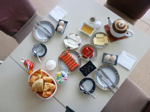 a table with plates of food and eggs and bread at Arena Hotel Shirvan in Əli Bayramlı Stansiyası