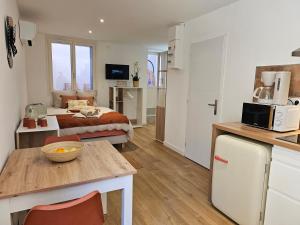 a kitchen and a bedroom with a bed in a room at Les Résidences de Collioure in Collioure