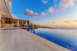 an infinity pool in a villa with a view of the ocean at 4 Bedroom Sea View Villa in Kalkan in Kalkan