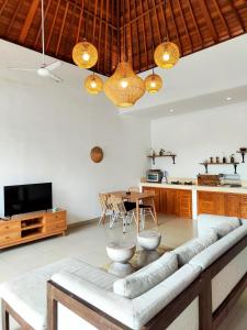 a living room with a couch and a table at HiKina - Best Value Private Pool Villa in Canggu