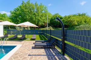a blue fence with benches next to a swimming pool at Holiday Home Petar by Rent Istria in Buje