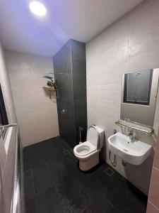 a bathroom with a toilet and a sink at Troika Kota Bharu by Larissa Stay in Kota Bharu
