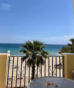 un tavolo su un balcone con vista sulla spiaggia di Casa Blue Bayou a Villajoyosa