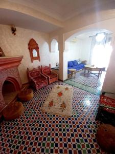 a living room with a fireplace and a tile floor at Charming Oasis in Marrakesh in Marrakech