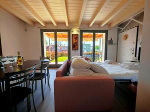 a baby laying on a bed in a room with a table at SG Luxury - Crystal Bay Apartment in Ronchi