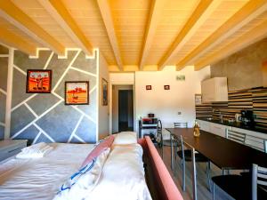 a bedroom with a bed and a table in a room at SG Luxury - Crystal Bay Apartment in Ronchi +31 photos