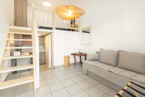 a living room with a couch and a loft bed at Mykonos Eight in Mýkonos City