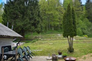 a group of chairs and a table in a garden at Grajska kmetija in Kočevje