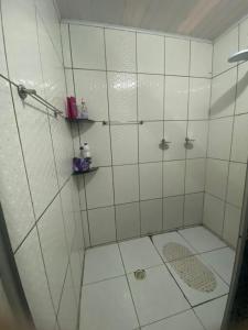 a shower with a glass door in a bathroom at Alugo casa festival de inverno in Garanhuns +11 photos