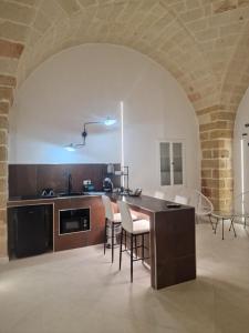 a kitchen with a table and chairs in a room at Home Belvedere in Brindisi