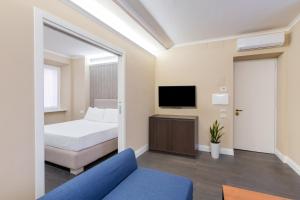 a hotel room with a bed and a tv at Maison dei Greci in Rome