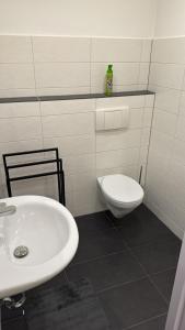 a bathroom with a white sink and a toilet at World of Esport in Bayreuth