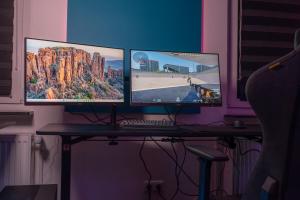 two computer monitors sitting on top of a desk at World of Esport in Bayreuth