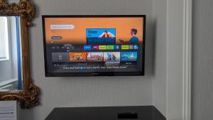 a flat screen tv hanging on a wall at Applewood Hotel in Bournemouth