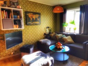 a living room with a couch and a table at VillaVasa Original in Transtrand