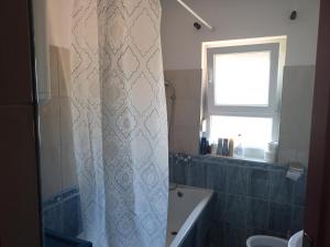 a bathroom with a shower curtain and a window at La Hacienda DD in Trebinje +27 photos