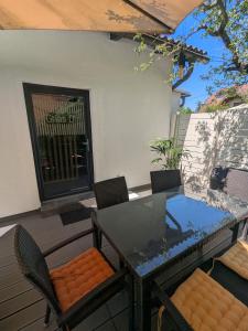 a dining table and chairs on a patio at Klagenfurt Apartment in Klagenfurt +24 photos