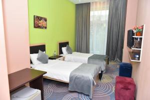 Postel nebo postele na pokoji v ubytování Arena Hotel Sumgait