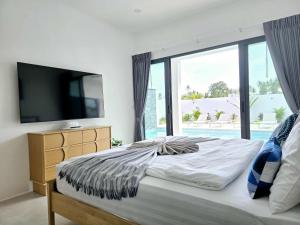 a bedroom with a large bed with a large window at Private villa near beach Koh Samui in Koh Samui +26 photos