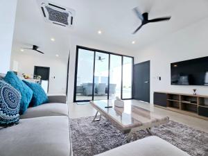 a living room with a couch and a table at Private villa near beach Koh Samui in Koh Samui