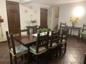 a dining room with a wooden table and chairs at Casa Maria Saturnia in Saturnia +7 photos