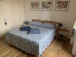 a bedroom with a bed with two pillows on it at Casa Maria Saturnia in Saturnia