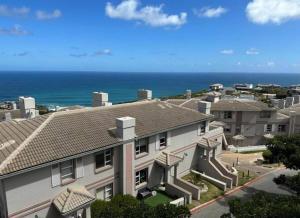a row of houses with the ocean in the background at 3 Bedroom Villa in Pinnacle Point Estate in Mossel Bay