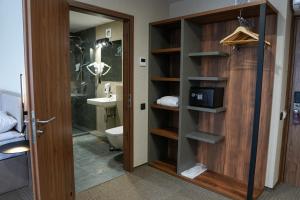 a bathroom with a toilet and a sink at Optima Collection River Park in Lutsk +40 photos