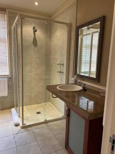 a bathroom with a shower and a sink at 3 Bedroom Villa in Pinnacle Point Estate in Mossel Bay