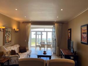 a living room with a couch and a table at 3 Bedroom Villa in Pinnacle Point Estate in Mossel Bay