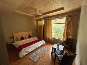 a bedroom with a bed and a large window at Neerangana Retreat in Chakrāta