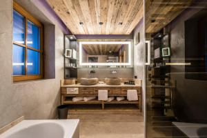 a bathroom with a sink and a tub at eva,VILLAGE in Saalbach-Hinterglemm