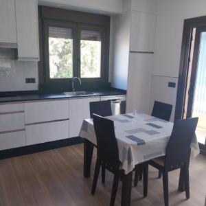 a kitchen with a table with chairs and a sink at Casa Vista Alegre en Oia in Oia +17 photos