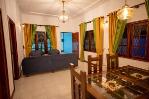 a living room with a couch and a glass table at Carmel Crown Villa in Hatton