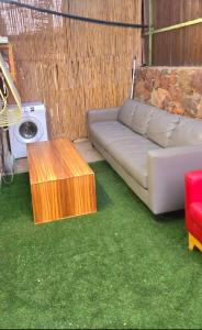 a living room with a couch and a table at BLAGO home Los Angeles 2 in Eilat
