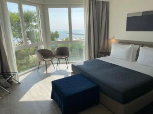 Postel nebo postele na pokoji v ubytování Hotel Petit Palais