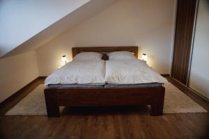 a bedroom with a bed with two pillows on it at Privat Agapi in Vrbov