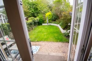 a view of a yard from a sliding glass door at Inverness Holiday Retreat - 2 Bedroom in Inverness +16 photos