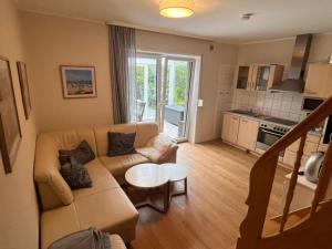 a living room with a couch and a table at !!!NEU!!! FEWO Sanna in Dornum
