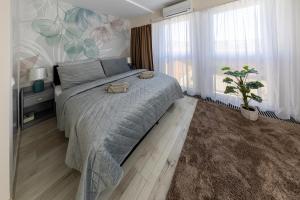 a bedroom with a bed with two towels on it at HelloWine Apartman III in Eger