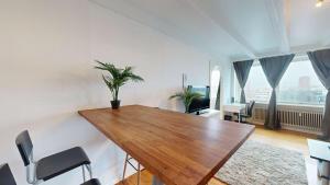 a dining room with a wooden table and chairs at Cozy Vesterbro apt in Aalborg