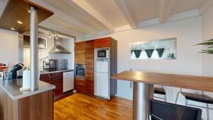 a kitchen with wooden cabinets and a counter top at Cozy Vesterbro apt in Aalborg