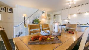 a kitchen and dining room with a table with a candle at Min y Mor Menai in Menai Bridge